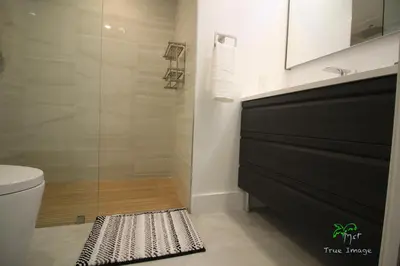 a bathroom with a shower with a glass door at Yacht Club at Aventura 2 Bed 2 bath Luxurius Cozy Brand New in Aventura