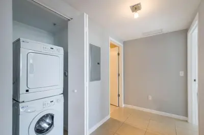 a laundry room with a washer and dryer in it at 4 BDR Sweeping Bayfront Elegance in Miami