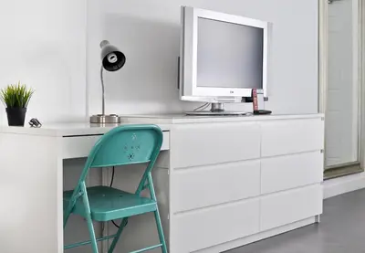 a white desk with a computer and a chair at Snooze in Fort Lauderdale