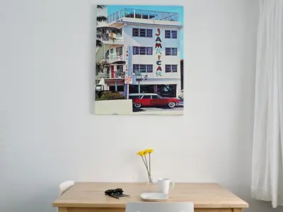 a table in a room with a picture of a building at Snooze in Fort Lauderdale