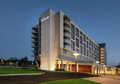 a hotel building with street lights in front of it at Hilton Miami Dadeland in South Miami