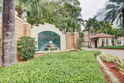 a sign in front of a building with a fountain at Renovated 2/2 Unit at Yacht Club/Aventura in Aventura