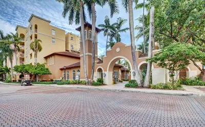 a building with a clock tower on a street at Renovated 2/2 Unit at Yacht Club/Aventura in Aventura