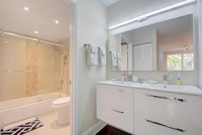 a white bathroom with a sink and a toilet at Renovated 2/2 Unit at Yacht Club/Aventura in Aventura