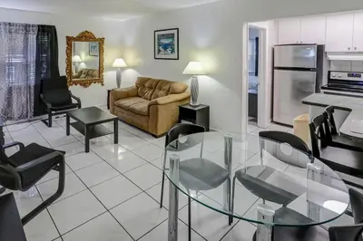 a living room with a glass table and a couch at Richard's Motel in Hollywood