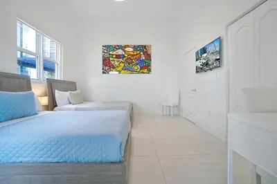 a white room with a bed and a couch at Miami Brickell 4 Bedrooms High Ceiling loft on the pool in Miami