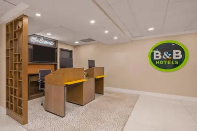 an office with a desk and a sign on the wall at B&B Hotel Miami Airport in Miami