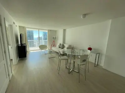 a living room with a glass table and chairs at Gorgeous apartment in Brickell in Miami
