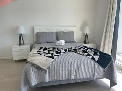 a bedroom with a large bed with two lamps at Gorgeous apartment in Brickell in Miami