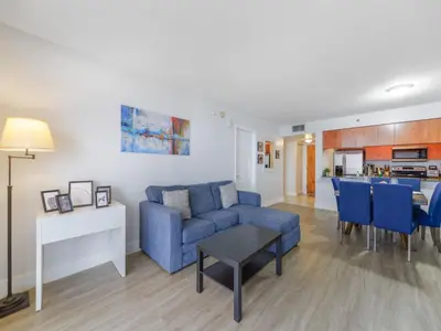 a living room with a blue couch and a table at Gorgeous apartment in Brickell in Miami