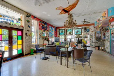 a room with colorful walls and tables and chairs at James Hotel in Miami Beach