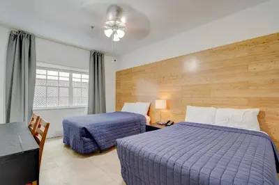 a hotel room with two beds and a window at James Hotel in Miami Beach