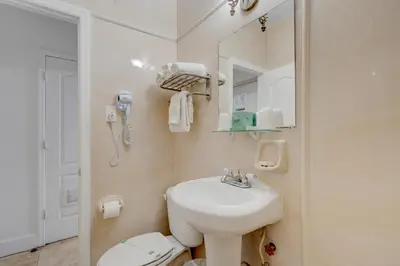 a bathroom with a sink and a toilet and a mirror at James Hotel in Miami Beach