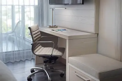 a desk with a chair next to a window at Courtyard Miami Coconut Grove in Miami
