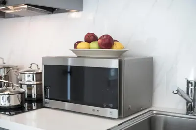 a bowl of apples sitting on top of a microwave at Sobe Lux in Miami Beach