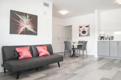 a living room with a couch and a table at Sobe Lux in Miami Beach