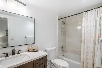 a bathroom with a toilet and a sink and a tub at Luxury Miami Condos in Miami Beach