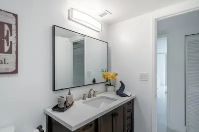 a bathroom with a sink and a mirror at Luxury Miami Condos in Miami Beach