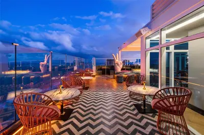 a balcony with tables and chairs on a ship at Beach House Fort Lauderdale, A Hilton Resort in Fort Lauderdale