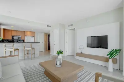 a living room with a tv on a wall at Beach House Fort Lauderdale, A Hilton Resort in Fort Lauderdale
