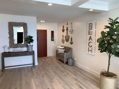 a living room with a chair and a mirror at Direct Ocean View Condo at Tides of Hollywood - 7N in Hollywood