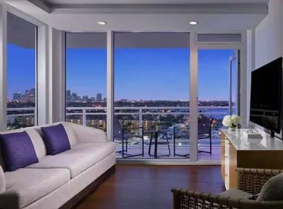 a living room with a couch and a large window at Hilton Fort Lauderdale Marina in Fort Lauderdale