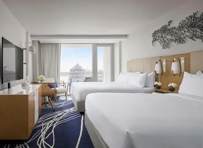 a hotel room with two beds and a television at Hilton Fort Lauderdale Marina in Fort Lauderdale