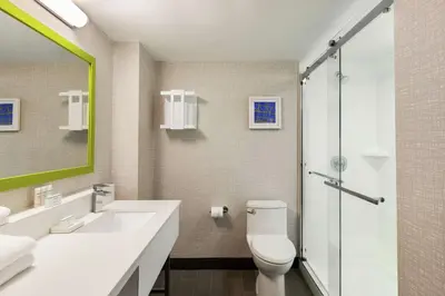a bathroom with a toilet and a sink and a shower at Hampton Inn & Suites Fort Lauderdale Airport in Hollywood
