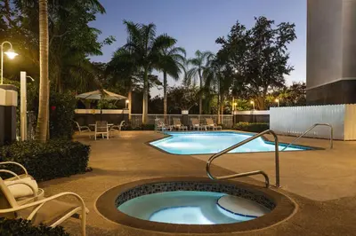 a swimming pool with a hot tub in a courtyard at Hampton Inn Pembroke Pines in Pembroke Pines