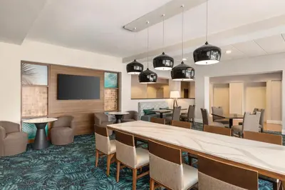 a dining room with a large table and chairs at Hampton Inn Pembroke Pines in Pembroke Pines