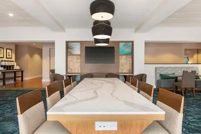 a conference room with a table and a television at Hampton Inn Pembroke Pines in Pembroke Pines