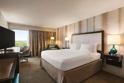 a hotel room with a large bed and a desk at Hampton Inn Pembroke Pines in Pembroke Pines