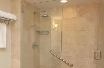 a bathroom with a shower with a glass door at GALLERY One - A DoubleTree Suites by Hilton Hotel in Fort Lauderdale