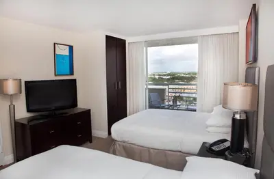 a hotel room with two beds and a television at GALLERY One - A DoubleTree Suites by Hilton Hotel in Fort Lauderdale