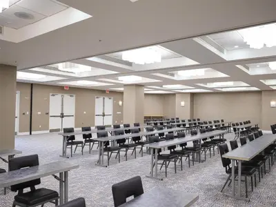 an empty room with tables and chairs in it at GALLERY One - A DoubleTree Suites by Hilton Hotel in Fort Lauderdale
