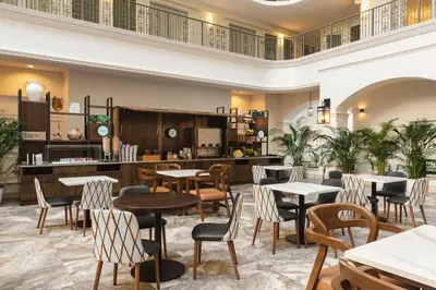 a restaurant with tables and chairs in a room at Embassy Suites by Hilton Fort Lauderdale 17th Street in Fort Lauderdale