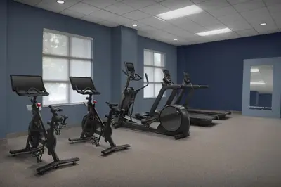 a gym with exercise bikes in a blue wall at Hampton Inn Fort Lauderdale Downtown Las Olas Area in Fort Lauderdale