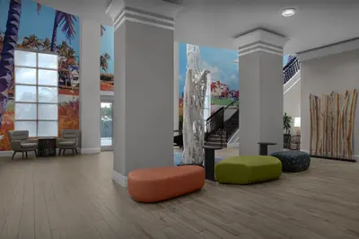 a lobby with a mural of a staircase and chairs at Hampton Inn Fort Lauderdale Downtown Las Olas Area in Fort Lauderdale