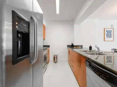 a kitchen with a stainless steel refrigerator and a sink at Beautiful Apartment in the Heart of Brickell in Miami