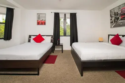 two beds in a room with red pillows at Apartments in the Heart of Miami - Port of Miami / Miami Airport in Miami