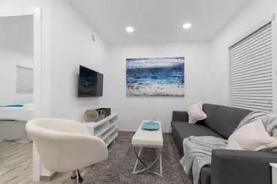 a living room with a couch and a bed at Renovated studio wocean view boardwalk steps in Hollywood