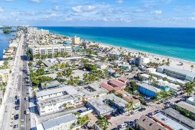 an aerial view of the beach and the ocean at Modern apt wqueen bed beach steps in Hollywood