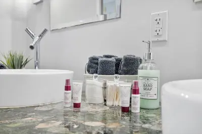 a bathroom counter with a sink and some bottles on it at Marvelous apartment in Brickell in Miami