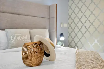 a hat and a basket on a bed at Marvelous apartment in Brickell in Miami