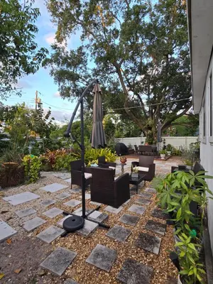 a patio with an umbrella and chairs and a table at Suite Life at Chez Mercedes in Miami