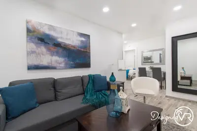 a living room with a couch and a table at Cozy apartment wsteps to beach boardwalk in Hollywood