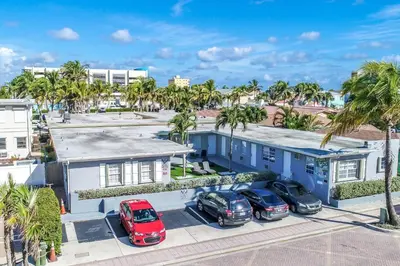 an aerial view of a blue building with cars parked in front at Modern studio wqueen bed beach views in Hollywood