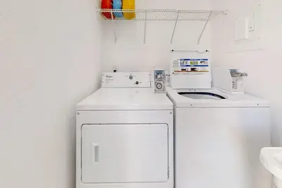 a white laundry room with a washer and dryer at Modern apartment wking bed beach views in Hollywood