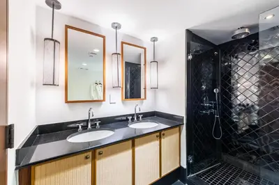a bathroom with two sinks and a shower at Oceanfront Private Condo at The Setai -2707 in Miami Beach
