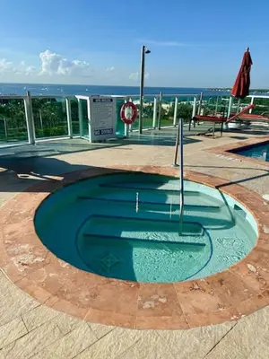 a small pool of water in the middle of a patio at Ocean View Balcony steps from Restaurants, Peacock Park & Marina in Miami